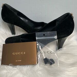 Authentic Gucci black suede pumps with gold decal
